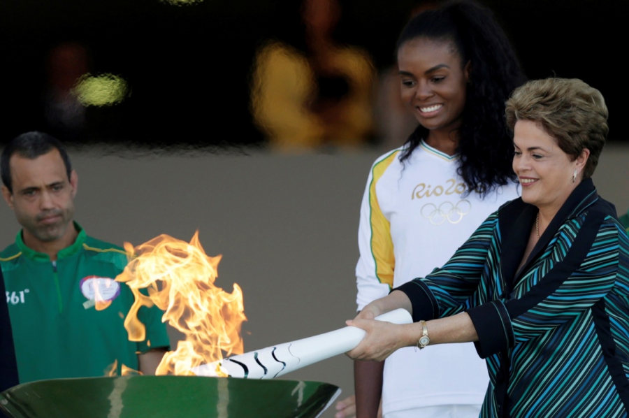 Brazil's President Dilma Rousseff lights a cauldron with the Olympic Flame Brazil's President Dilma Rousseff lights a cauldron with the Olympic Flame
